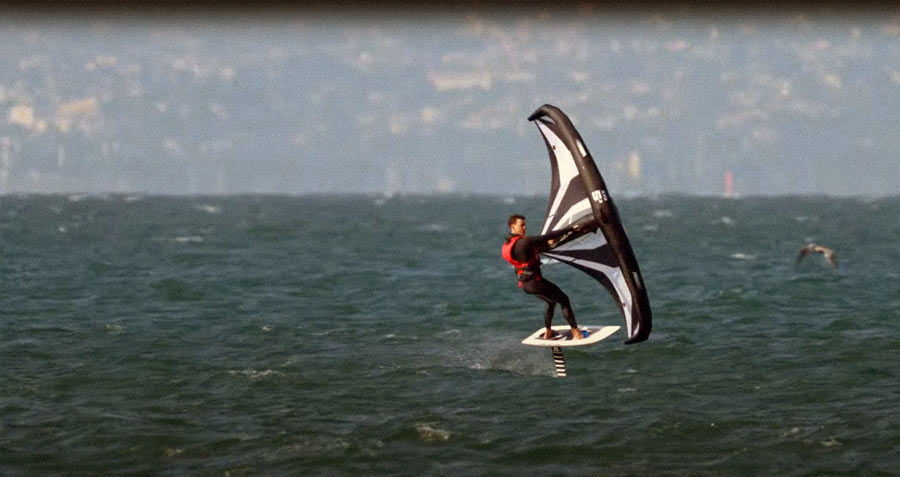 wingsurfer using foil in strong winds at sea